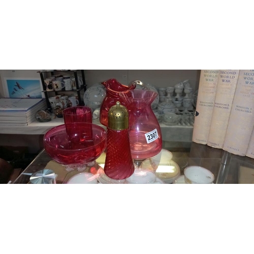 2307 - A quantity of cranberry items including jug, sugar shaker etc