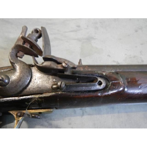 692 - A early Brown Bess musket, complete including hammer mechanism but all woodwork needs serious repair... 