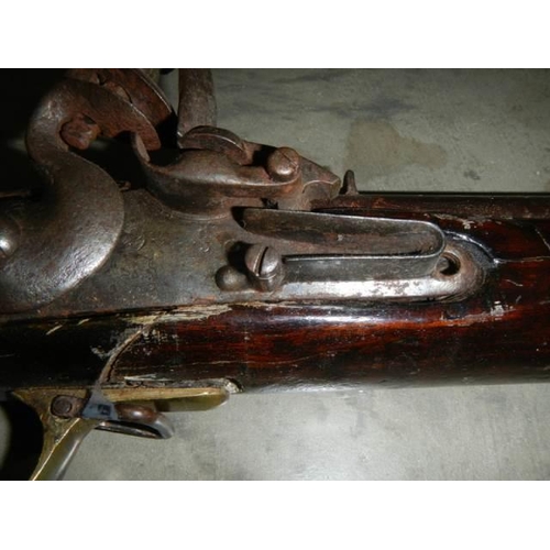 692 - A early Brown Bess musket, complete including hammer mechanism but all woodwork needs serious repair... 