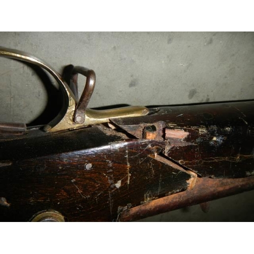 692 - A early Brown Bess musket, complete including hammer mechanism but all woodwork needs serious repair... 