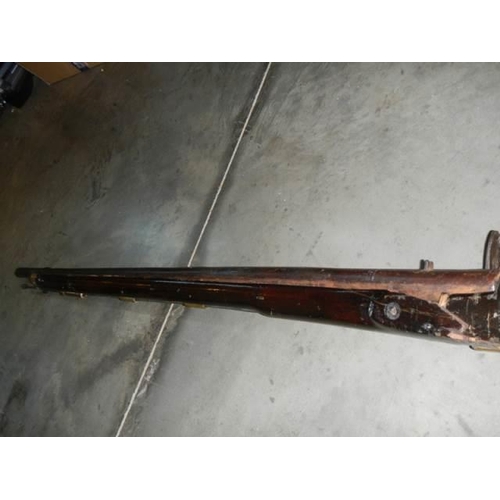 692 - A early Brown Bess musket, complete including hammer mechanism but all woodwork needs serious repair... 