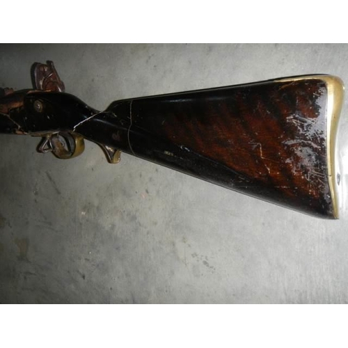 692 - A early Brown Bess musket, complete including hammer mechanism but all woodwork needs serious repair... 