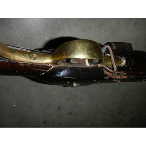 692 - A early Brown Bess musket, complete including hammer mechanism but all woodwork needs serious repair... 