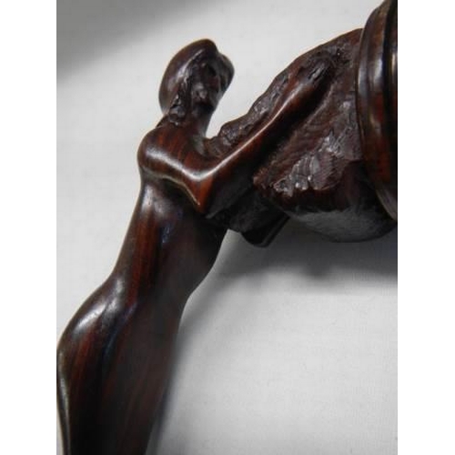 695 - A carved mahogany walking stick.