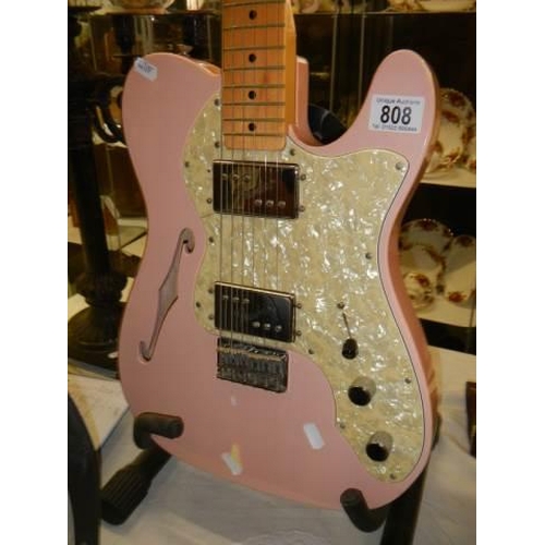 808 - A Fender Telecaster thinline shell pink guitar with black hard case.