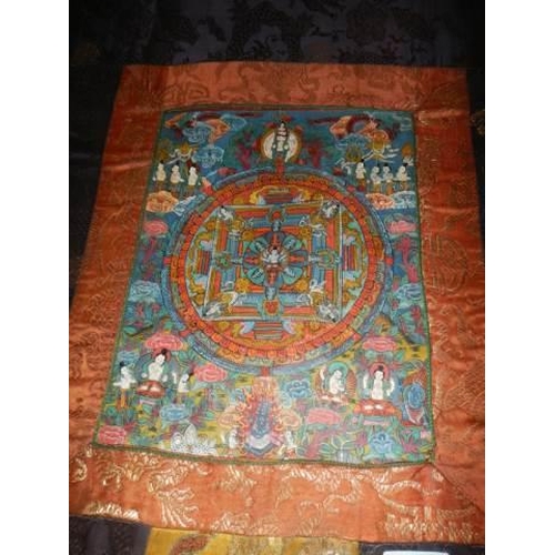 843 - . A Tibetan Buddhist hand-painted mandala thangka set in silk brocade. Images include detailed manif... 