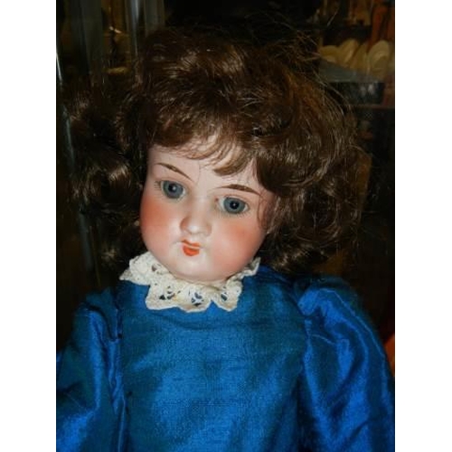 874 - A German bisque headed AM 390 doll.