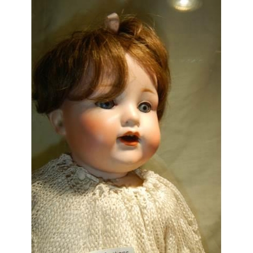 884 - An Armand Marseille porcelain headed doll, AM 990 Germany.