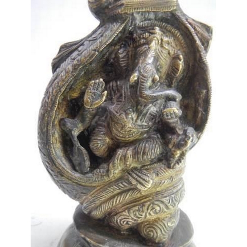 898 - Ornate heavy bronze of Hindu god Ganesha seated in a conch shell set on a lotus base. H 21cm x W10cm