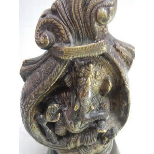 898 - Ornate heavy bronze of Hindu god Ganesha seated in a conch shell set on a lotus base. H 21cm x W10cm