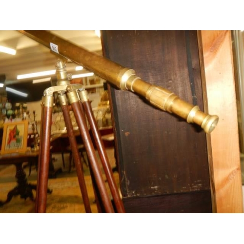 902 - A 100cm brass telescope on brass bound mahogany tripod stand.