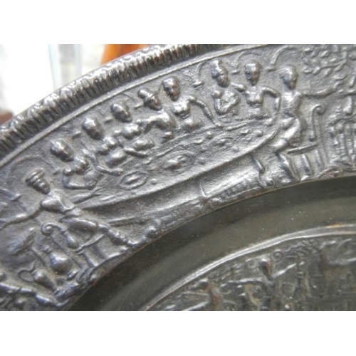 912 - A cast metal embossed plate.