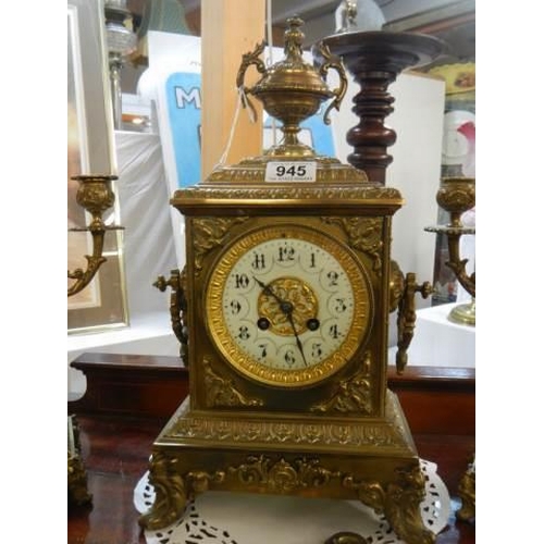 945 - A three piece brass clock garniture in working order.