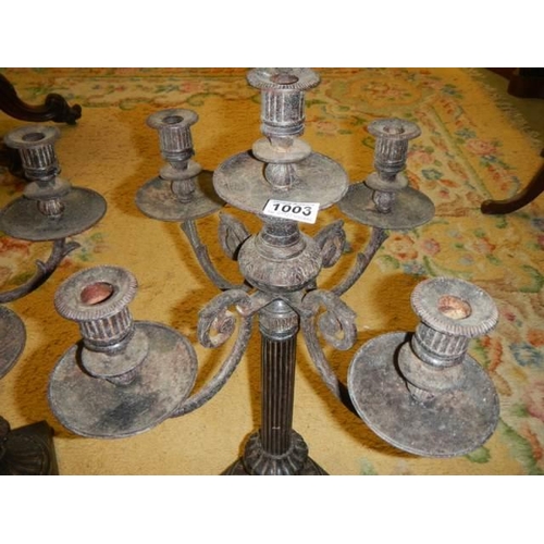 1003 - A pair of heavy iron candelabra.