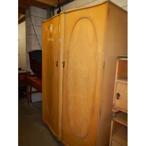 1049 - A four piece mid 20th century bedroom suite comprising wardrobe, 2 over 3 chest of drawers and 2 bed... 