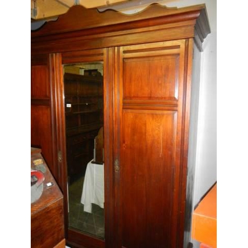 1054 - A mahogany three door combination wardrobe, COLLECT ONLY.