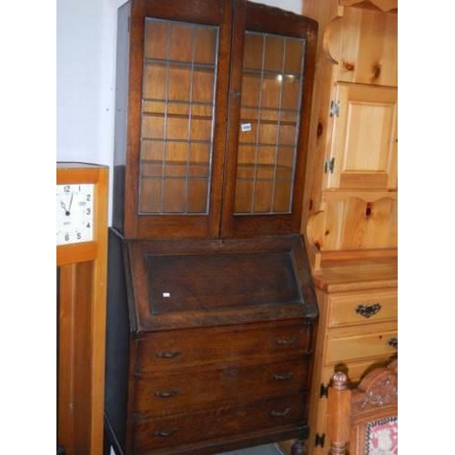 1094 - An oak bureau bookcase with lead glazed top, COLLECT ONLY.