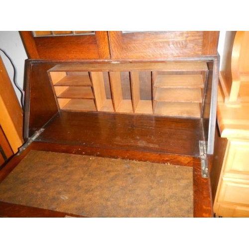 1094 - An oak bureau bookcase with lead glazed top, COLLECT ONLY.