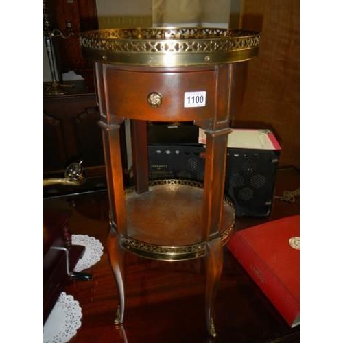 1100 - A circular mahogany table with brass gallery. COLLECT ONLY.