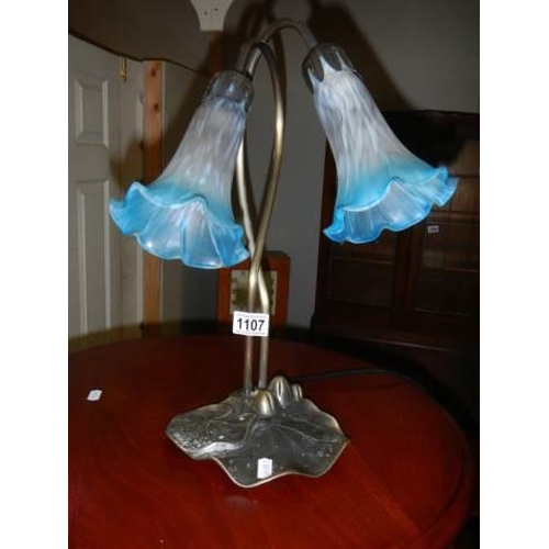 1107 - A twin light table lamp with glass shades.