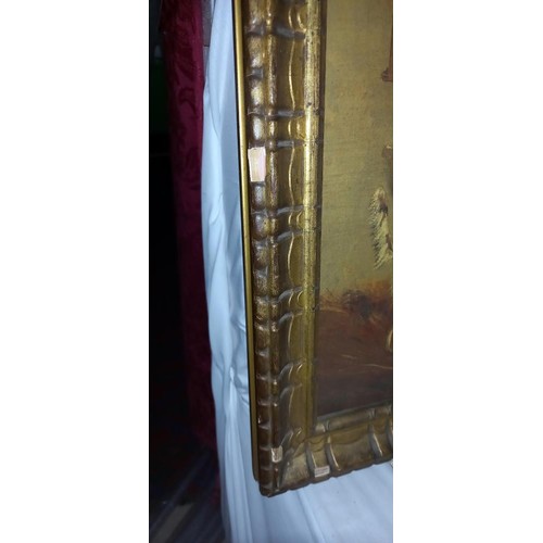 611 - A gilt framed painting of a horse and dog in a stable.