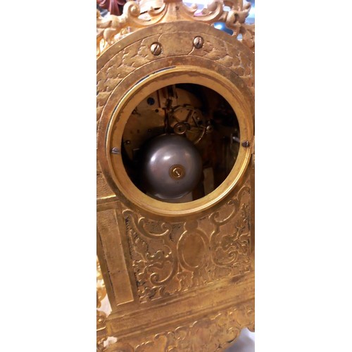 913 - A French ormolu mantel clock with enamel dial and porcelain panel.