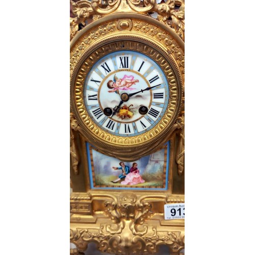 913 - A French ormolu mantel clock with enamel dial and porcelain panel.