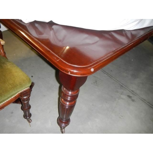 1121 - A Victorian mahogany wind out dining table with eight matching chairs, COLLECT ONLY.