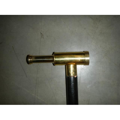 1128 - A walking stick with brass telescope handle.