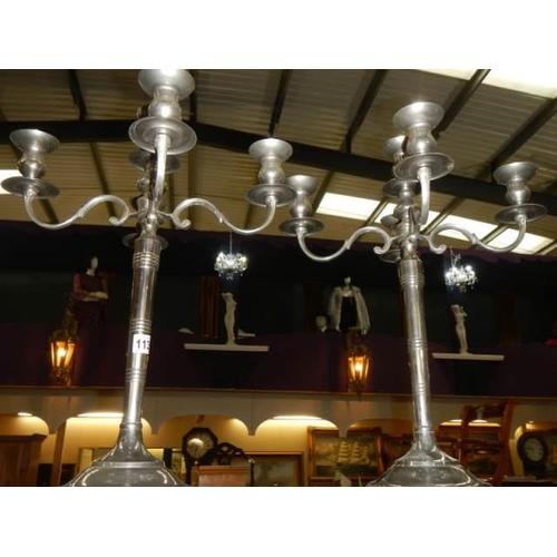 1139 - A pair of four branch silver plate candelabra.