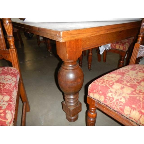 1149 - A large oak wind out table with ten matching chairs, (122cm x 240cm x 72cm high) COLLECT ONLY.