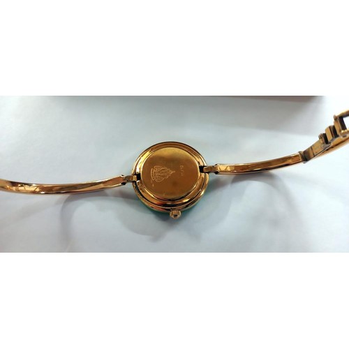 167 - A Gucci ladies wrist watch with interchangable bezels with original 1991 purchase receipt.