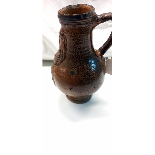 354 - A 'Bachanalian' salt glaze jug (possibly 18th century). This is a Bellarmine jug possibly 17th rathe... 