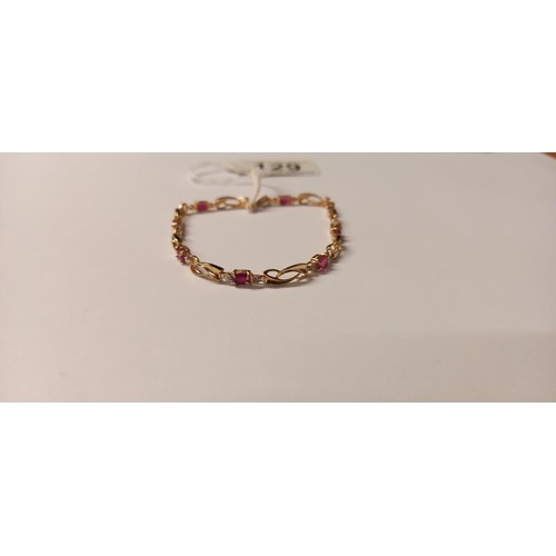 129 - A ruby bracelet with eight rubies set in 10ct gold stamped, Birthstone for July.