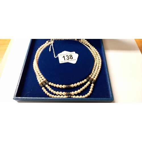 138 - A three row pearl necklace.