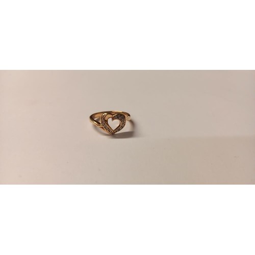 145 - A lovely diamond chip set heart ring in gold, size O, 2.8 grams. (Unmarked)