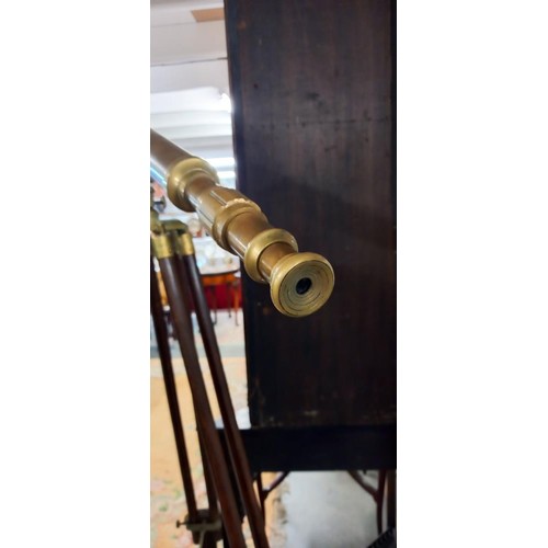 902 - A 100cm brass telescope on brass bound mahogany tripod stand.