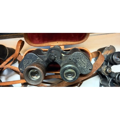 1085 - A quantity of cased binoculars.