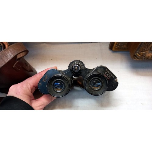 1085 - A quantity of cased binoculars.