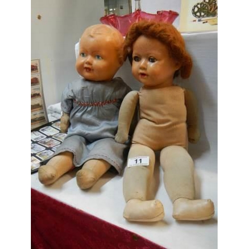 11 - Two 1950's dolls with cloth bodies.