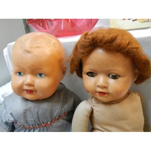 11 - Two 1950's dolls with cloth bodies.