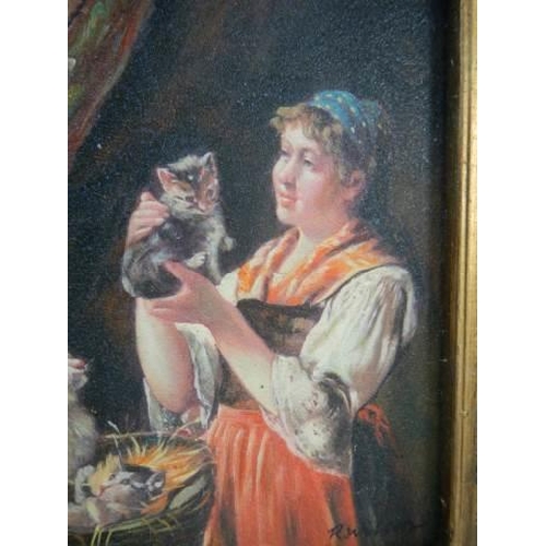 12 - A gilt framed study of a lady with cat and kittens.