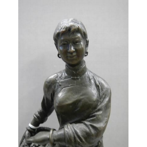 21 - A Chinese bronze female figure.
