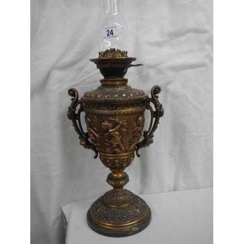 24 - An old spelter oil lamp featuring cherubs and with a drop in font.