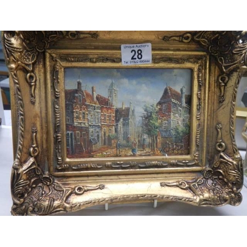 28 - A gilt framed street scene,
