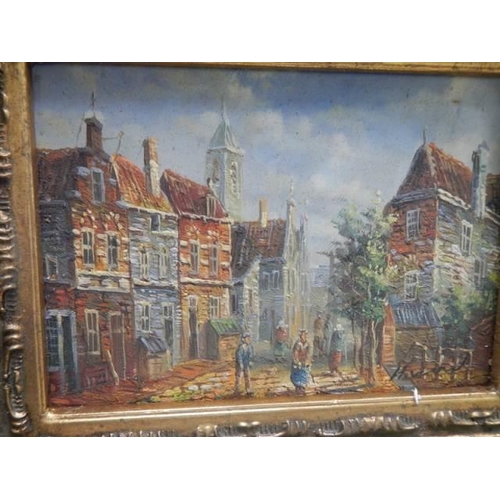 28 - A gilt framed street scene,
