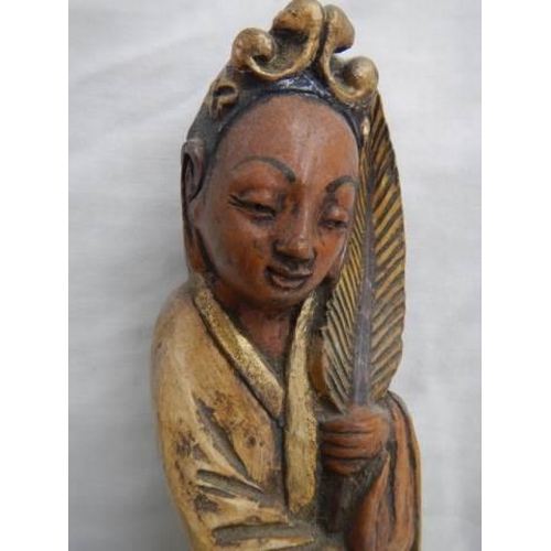 33 - A carved wood oriental figure.