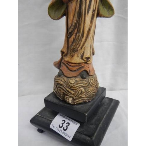 33 - A carved wood oriental figure.