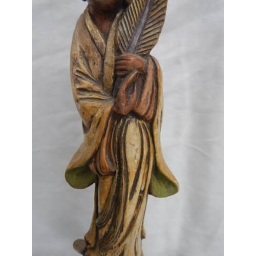 33 - A carved wood oriental figure.