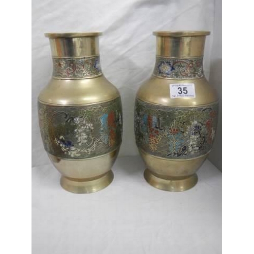 35 - A pair of Chinese vases with cloissonne style decoration.